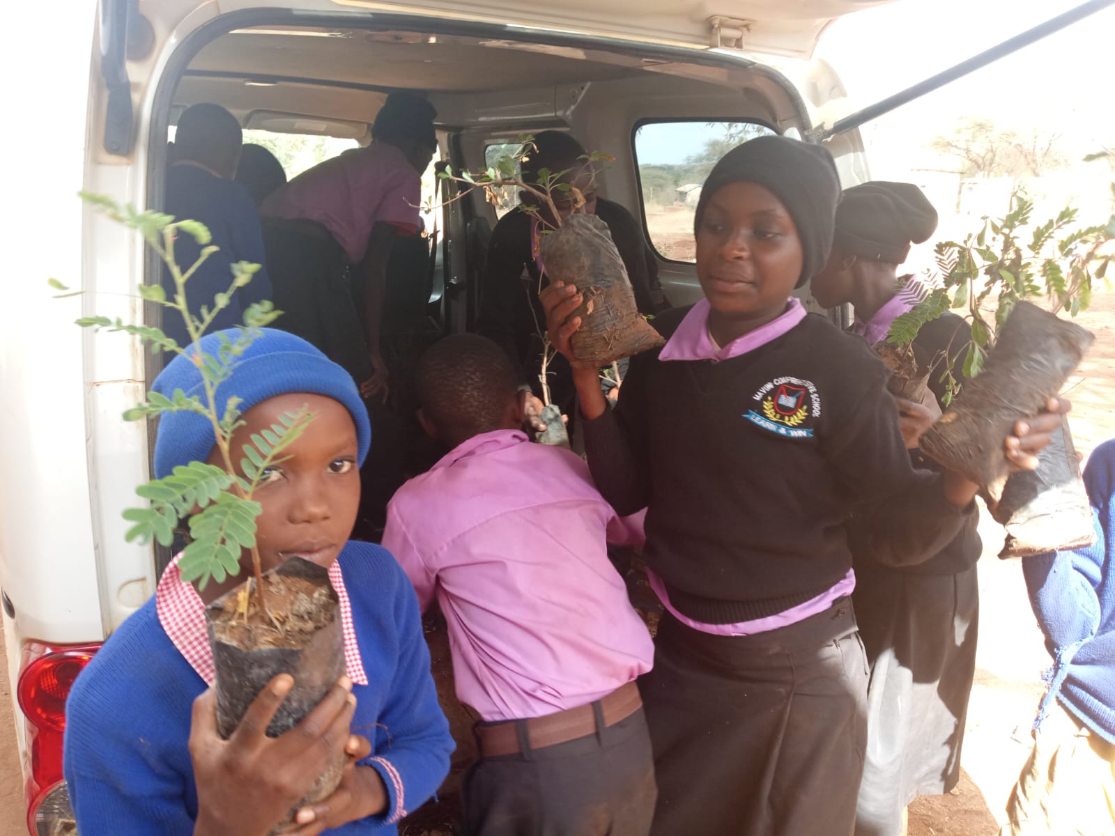 Students with seedlings for Genesis Green Schools